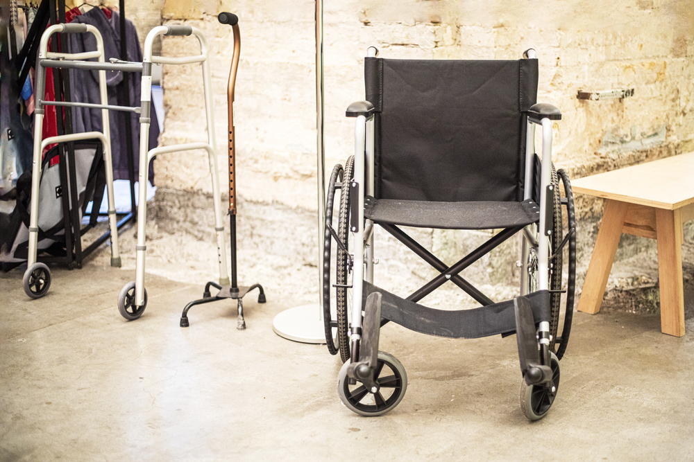 Mobility aids such as wheelchairs and walkers neatly arranged in a community space